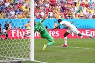 BRASILIA, BRAZIL - JUNE 26:  Asamoah Gyan of Ghana scores his team's first goal past goalkeeper Beto of Portugal during the 2014 FIFA World Cup Brazil Group G match between Portugal and Ghana at Estadio Nacional on June 26, 2014 in Brasilia, Brazil.  (Photo by Adam Pretty/Getty Images)